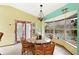 Dining area with glass table, rattan chairs, and pool view at 13494 Tyringham St, Spring Hill, FL 34609