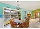 Dining area with glass table, rattan chairs, and pool view at 13494 Tyringham St, Spring Hill, FL 34609