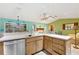 Kitchen with island, wood cabinets, and a corner sink at 13494 Tyringham St, Spring Hill, FL 34609