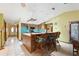 Kitchen with island, wood cabinets, and bar stools at 13494 Tyringham St, Spring Hill, FL 34609