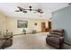 Living room featuring a double ceiling fan and light wood flooring at 13494 Tyringham St, Spring Hill, FL 34609