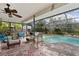 Inviting screened pool area with patio furniture and a tranquil atmosphere at 13494 Tyringham St, Spring Hill, FL 34609