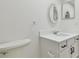 Bathroom with white vanity, quartz countertop, and oval mirror at 13602 S Village Dr # 1112, Tampa, FL 33618