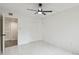 Bright bedroom with ceiling fan and access to hallway at 13602 S Village Dr # 1112, Tampa, FL 33618