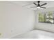 Spacious bedroom featuring a ceiling fan and large window at 13602 S Village Dr # 1112, Tampa, FL 33618