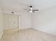 Bright bedroom with ceiling fan and door to bathroom at 13602 S Village Dr # 1112, Tampa, FL 33618