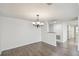 Spacious dining room with hardwood floors and elegant chandelier at 13602 S Village Dr # 1112, Tampa, FL 33618