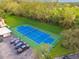 Community tennis court with blue surface and fencing at 13602 S Village Dr # 1112, Tampa, FL 33618