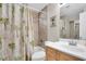 Bathroom featuring tiled shower/tub combo, toilet, and vanity with sink at 1400 Solar Dr, Holiday, FL 34691