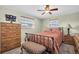 Bedroom with a ceiling fan, two windows, and a full size bed at 1400 Solar Dr, Holiday, FL 34691