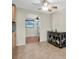 Bright dining area features tile flooring, decorative cabinet, and a ceiling fan at 1400 Solar Dr, Holiday, FL 34691