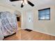 View of the living room featuring laminate wood-look floors and an exterior entry door at 1400 Solar Dr, Holiday, FL 34691