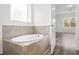 Oval soaking tub and walk-in shower with modern tile at 15171 Pomp Parkway, Weeki Wachee, FL 34614