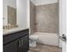 Bathroom boasts granite countertop, dark vanity, and tiled shower/tub combo at 15171 Pomp Parkway, Weeki Wachee, FL 34614