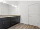 Double vanity bathroom with granite countertop and dark cabinets at 15171 Pomp Parkway, Weeki Wachee, FL 34614