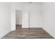 Empty bedroom with wood-look floors and an open door at 15171 Pomp Parkway, Weeki Wachee, FL 34614