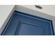 Close-up of a navy blue front door, showcasing its trim and hardware at 15171 Pomp Parkway, Weeki Wachee, FL 34614