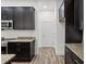 View of kitchen with dark cabinets and granite countertops at 15171 Pomp Parkway, Weeki Wachee, FL 34614