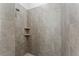 Walk-in shower with tiled walls and built-in shelves at 15171 Pomp Parkway, Weeki Wachee, FL 34614