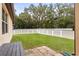 Backyard with grassy area, fence, and patio at 15579 Stone House Dr, Brooksville, FL 34604