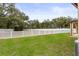 Large backyard with grassy area and white picket fence at 15579 Stone House Dr, Brooksville, FL 34604