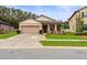 Charming one-story home with a two-car garage and well-manicured lawn at 15579 Stone House Dr, Brooksville, FL 34604