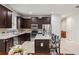 Modern kitchen with dark cabinetry, stainless steel appliances, and granite countertops at 15579 Stone House Dr, Brooksville, FL 34604