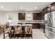 Modern kitchen with dark wood cabinets and granite countertops at 15579 Stone House Dr, Brooksville, FL 34604