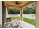 Covered patio overlooking a fenced-in backyard at 15579 Stone House Dr, Brooksville, FL 34604