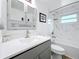 Updated bathroom with a bathtub, vanity, and marble-look walls at 1600 Pennsylvania Ne Ave, St Petersburg, FL 33703