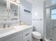 Updated bathroom with white vanity, marble shower, and tiled floor at 1600 Pennsylvania Ne Ave, St Petersburg, FL 33703