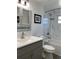 Updated bathroom with gray vanity and marble shower at 1600 Pennsylvania Ne Ave, St Petersburg, FL 33703