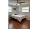 Cozy bedroom with wood floors and a ceiling fan at 1600 Pennsylvania Ne Ave, St Petersburg, FL 33703