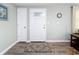 Front entry with white door, wood-look floors, and area rug at 1600 Pennsylvania Ne Ave, St Petersburg, FL 33703