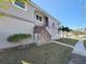 Gray two-story house with stone steps, landscaping, and American flag at 1600 Pennsylvania Ne Ave, St Petersburg, FL 33703