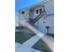 House entrance with stairs, stone accents, and American flag at 1600 Pennsylvania Ne Ave, St Petersburg, FL 33703