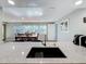 Kitchen features a large island, granite countertops and modern sink at 1600 Pennsylvania Ne Ave, St Petersburg, FL 33703