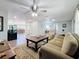 Living room with large TV, comfortable seating, and wood-look floors at 1600 Pennsylvania Ne Ave, St Petersburg, FL 33703