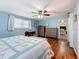 Main bedroom with light blue walls, wood floors, and a ceiling fan at 1600 Pennsylvania Ne Ave, St Petersburg, FL 33703