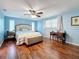 Main bedroom with wood floors, ceiling fan, and plenty of natural light at 1600 Pennsylvania Ne Ave, St Petersburg, FL 33703