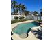 Inviting freeform swimming pool with a spa and surrounding patio at 1600 Pennsylvania Ne Ave, St Petersburg, FL 33703