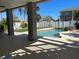 Relaxing pool area with covered patio and view of backyard at 1600 Pennsylvania Ne Ave, St Petersburg, FL 33703