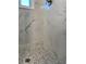 Modern shower with pebble floor and marble surround at 1600 Pennsylvania Ne Ave, St Petersburg, FL 33703