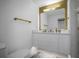 Modern bathroom with white vanity, gold accents, and a large mirror at 16015 Redington Dr, Redington Beach, FL 33708