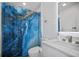 Clean bathroom with a blue shower curtain and white vanity at 16015 Redington Dr, Redington Beach, FL 33708