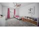 Cozy bedroom with twin beds, gray carpet, and whimsical wall art at 16015 Redington Dr, Redington Beach, FL 33708