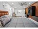 Main bedroom with king bed, wood wall, and large TV at 16015 Redington Dr, Redington Beach, FL 33708