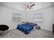 bedroom with twin beds, gray carpet, and ceiling fan at 16015 Redington Dr, Redington Beach, FL 33708