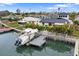 Private boat dock with lift, offering convenient waterfront access at 16015 Redington Dr, Redington Beach, FL 33708