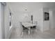 Modern dining room features a white table with gray chairs at 16015 Redington Dr, Redington Beach, FL 33708